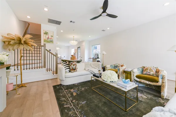 a living room with furniture and wooden floor