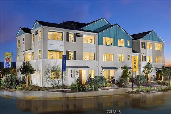 a front view of a building with lake view and glass windows