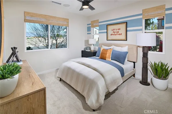 a bedroom with a bed and a potted plant