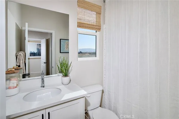 a bathroom with a sink toilet and mirror
