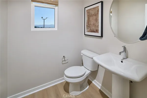a white toilet sitting next to a bathroom sink