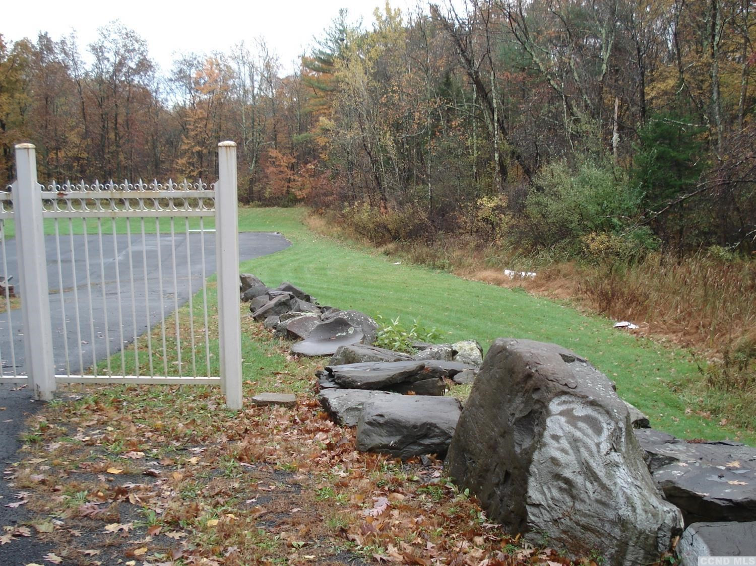 a view of backyard with outdoor seating and green space