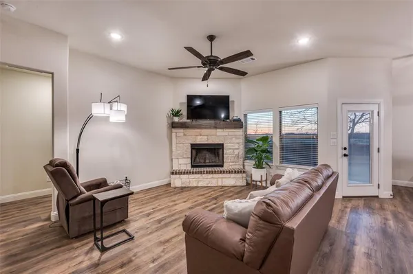 a living room with furniture a fireplace and a flat screen tv