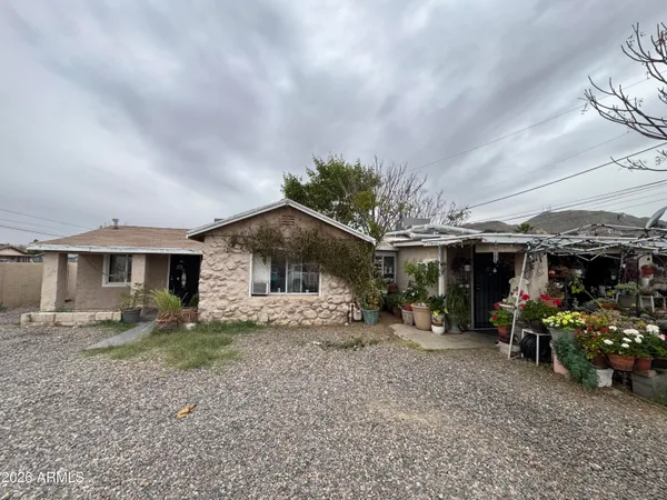 a view of a house with a yard and sitting area