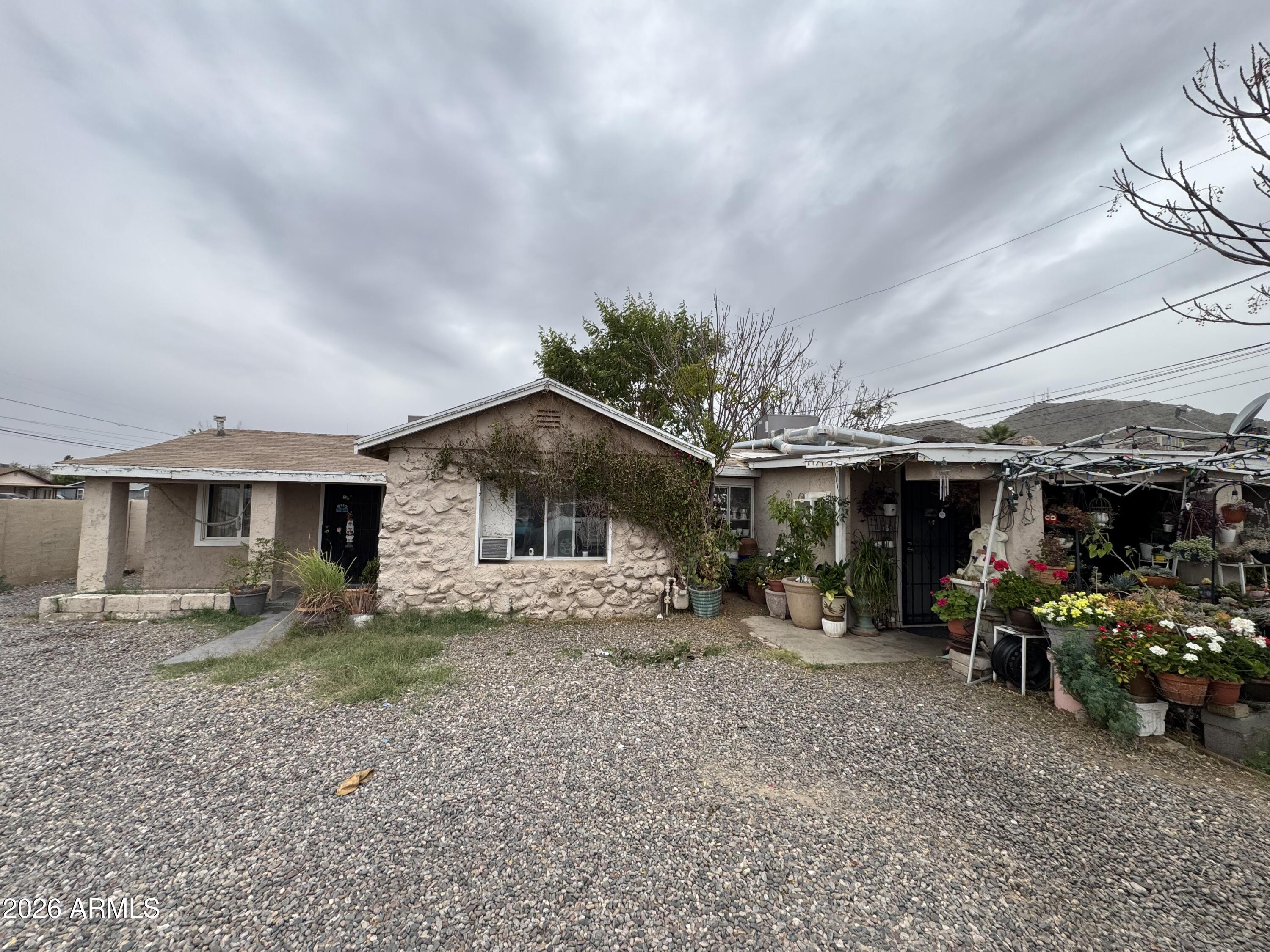 a view of a house with a yard and sitting area