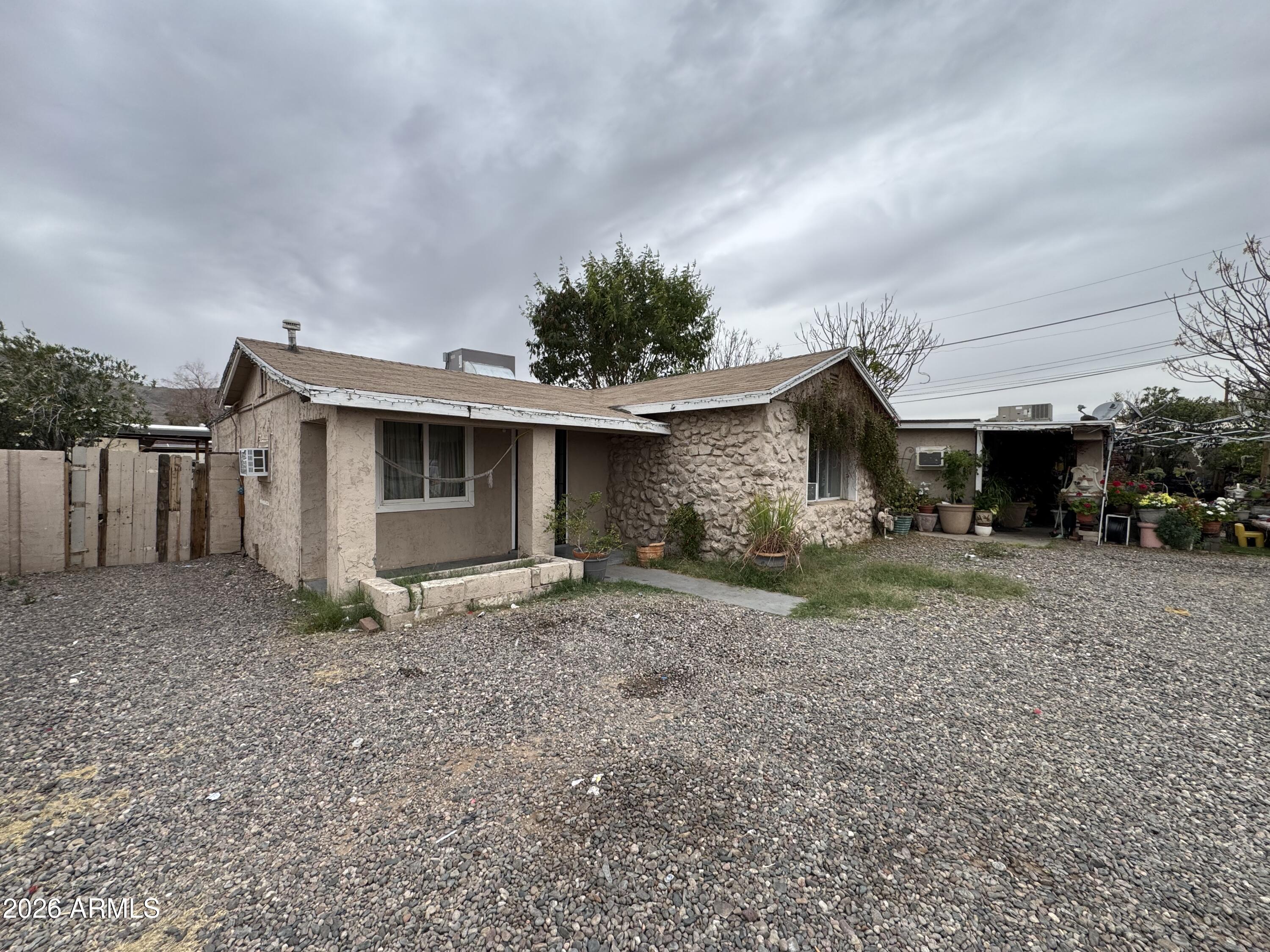 740 West Cinnabar Avenue Phoenix, AZ 85021 - Photo 2 of 26 a view of a house with a backyard and a tree