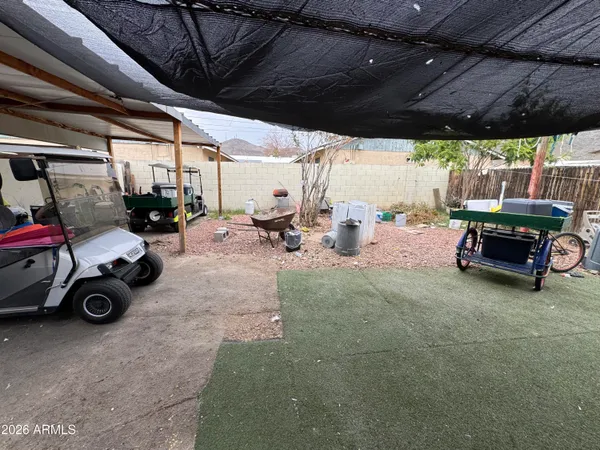 a view of a chairs and table in a backyard