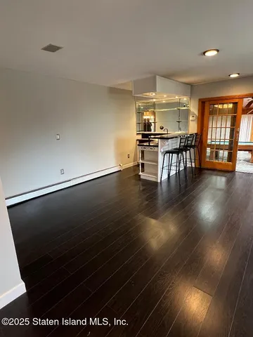 a room with lots of furniture and wooden floor