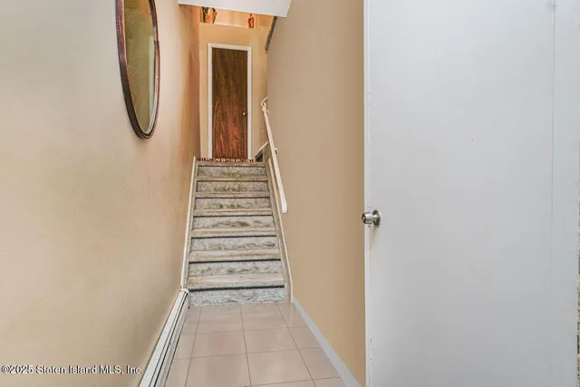 a view of a room with white walls and white door