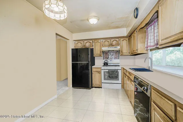 a kitchen with stainless steel appliances a refrigerator sink and cabinets