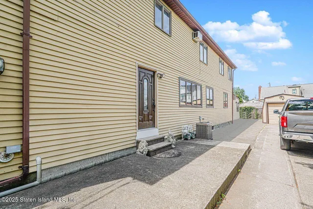 a view of a white house with many windows