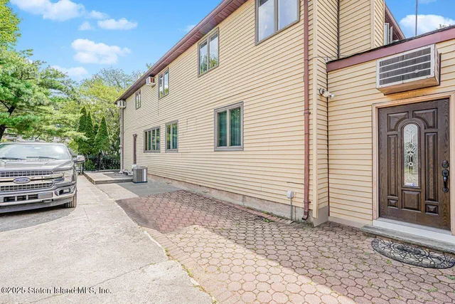 a view of a car park in front of a house