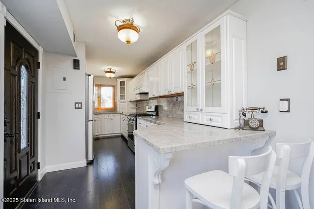 a dining room with furniture and a chandelier