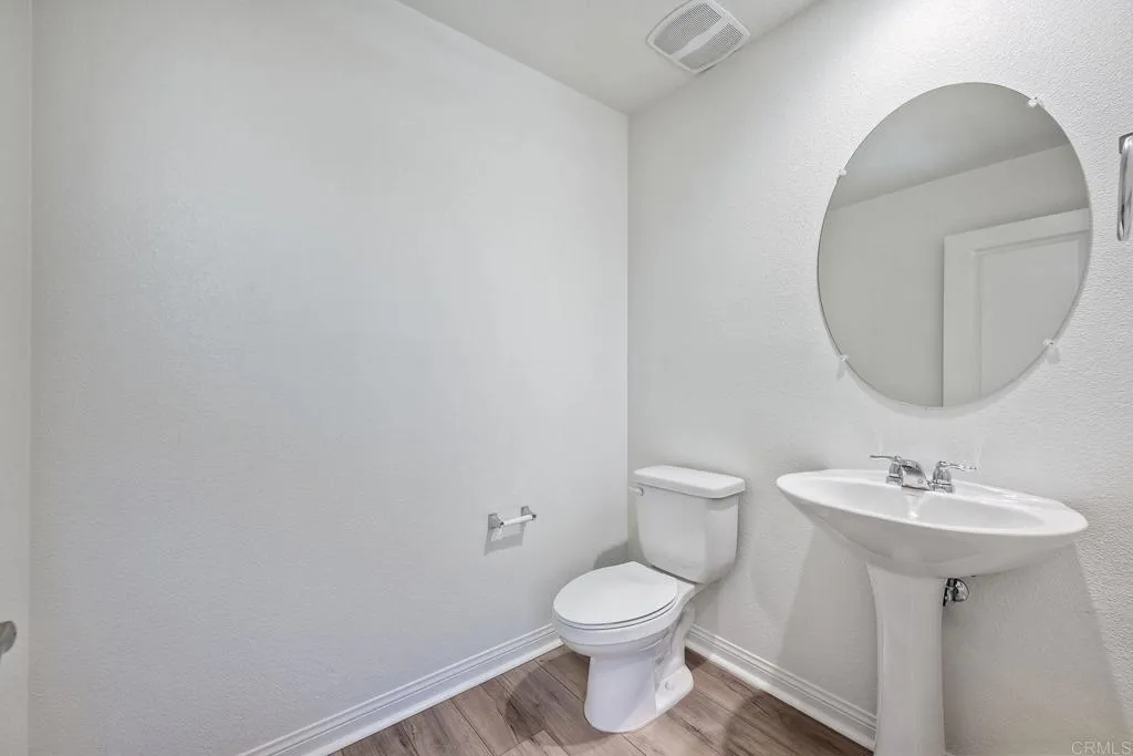 295 Mission Villas Road San Marcos, CA 92069 - Photo 11 of 29 a bathroom with a toilet sink and mirror