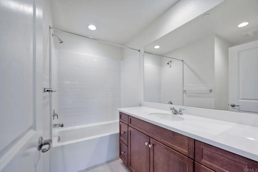 295 Mission Villas Road San Marcos, CA 92069 - Photo 14 of 29 a bathroom with a tub sink shower and mirror