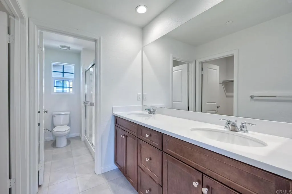 295 Mission Villas Road San Marcos, CA 92069 - Photo 16 of 29 a bathroom with a double vanity sink mirror and toilet