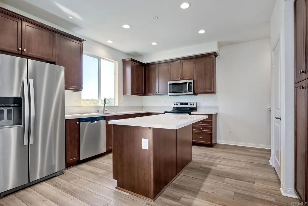 295 Mission Villas Road San Marcos, CA 92069 - Photo 9 of 29 a kitchen with stainless steel appliances granite countertop a refrigerator a sink dishwasher a stove top oven a refrigerator and cabinets