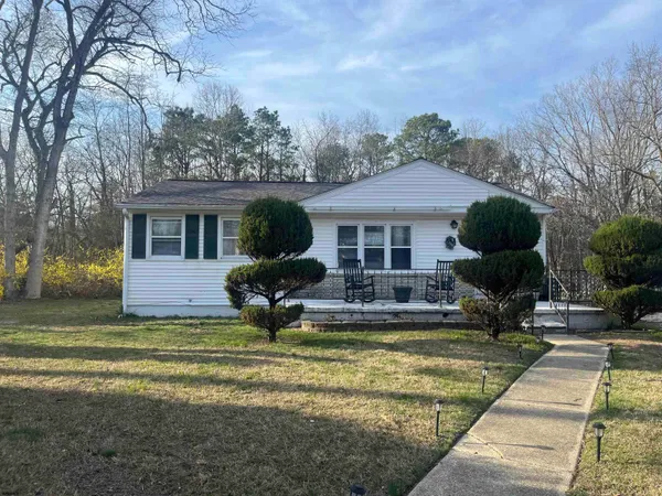 a front view of a house with swimming pool and glass windows