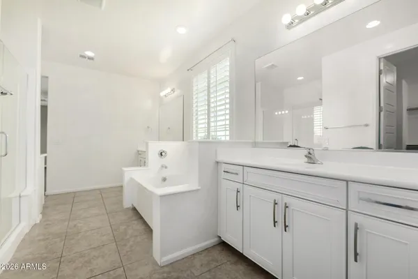 a bathroom with a sink a tub and a mirror