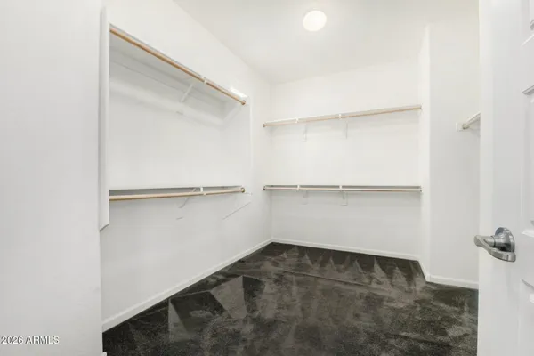 a view of walk in closet with empty racks