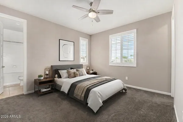 a bedroom with a bed and a window