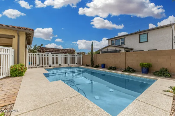 a view of a house with backyard and sitting area