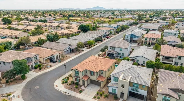 an aerial view of residential houses with outdoor space