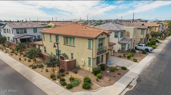 a view of a white house next to a yard