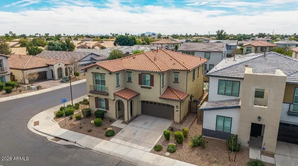 a aerial view of a brick house next to a yard