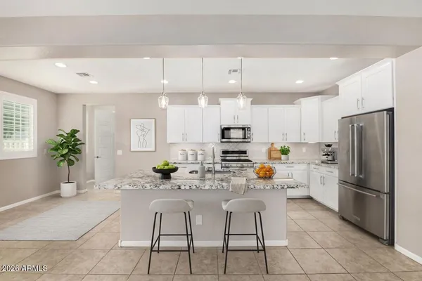 a kitchen with stainless steel appliances a refrigerator sink and cabinets