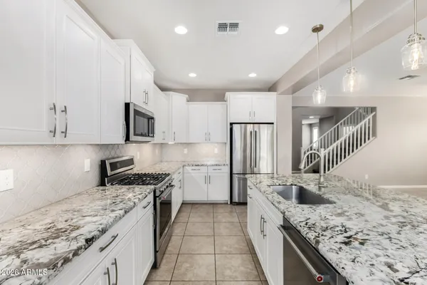 a kitchen with a sink stove and refrigerator