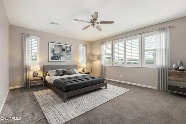 a bedroom with a large bed and a window