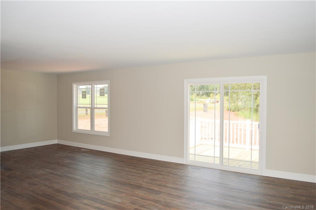4831 Kemp Dellinger Road Maiden, NC 28650 - Photo 2 of 20 a view of an empty room with wooden floor and a window