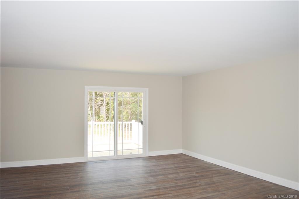 4831 Kemp Dellinger Road Maiden, NC 28650 - Photo 3 of 20 a view of an empty room with wooden floor and a window
