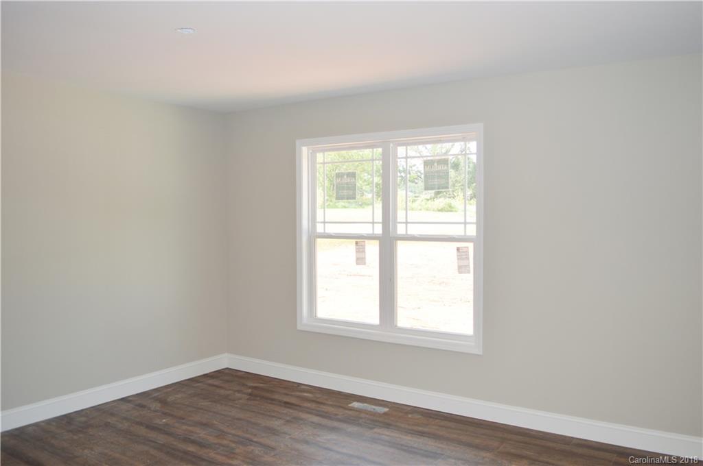 4831 Kemp Dellinger Road Maiden, NC 28650 - Photo 4 of 20 an empty room with wooden floor and windows