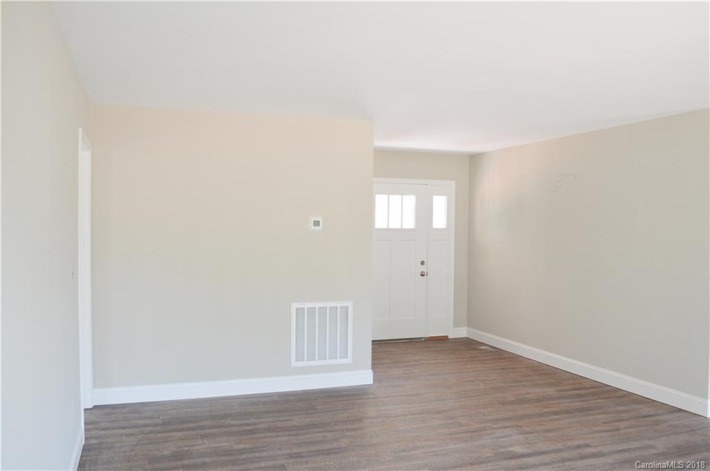 4831 Kemp Dellinger Road Maiden, NC 28650 - Photo 8 of 20 a view of an empty room with wooden floor and windows