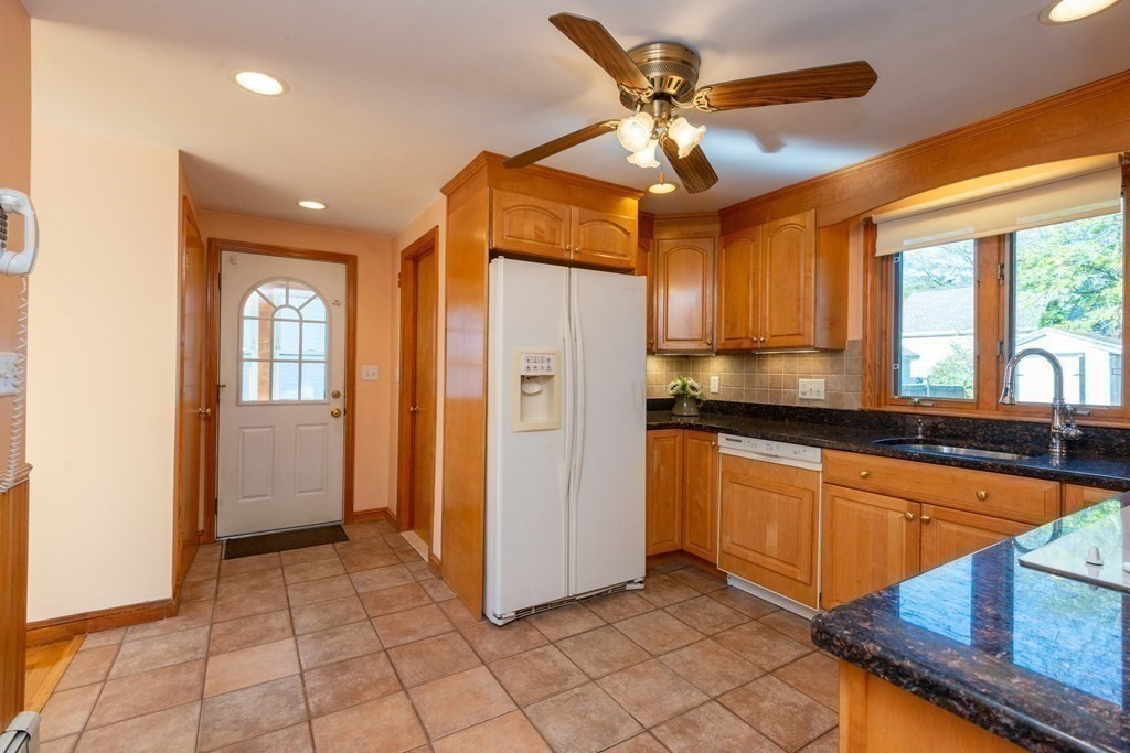 114 Spring Street Stoneham, MA 02180 - Photo 18 of 41 a kitchen with stainless steel appliances granite countertop a refrigerator and a sink