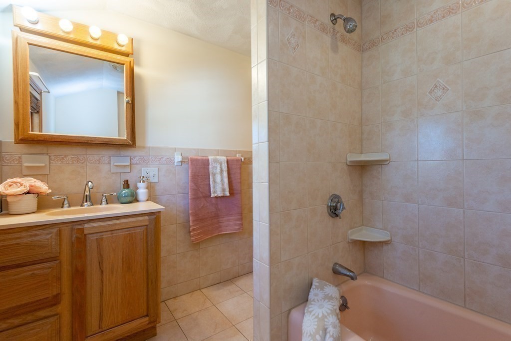 114 Spring Street Stoneham, MA 02180 - Photo 23 of 41 a bathroom with a sink a toilet and shower
