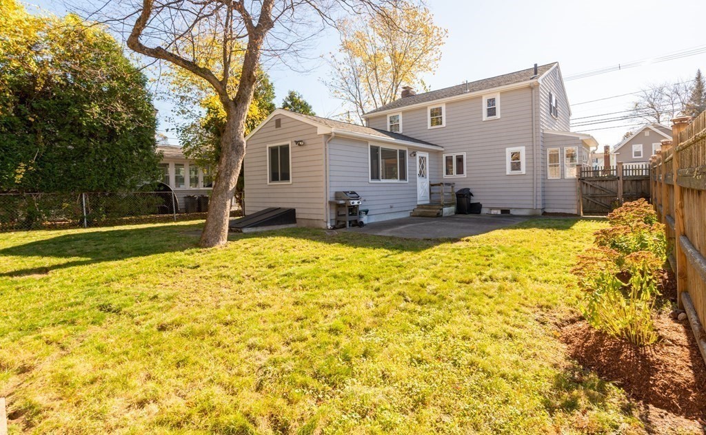 114 Spring Street Stoneham, MA 02180 - Photo 37 of 41 a view of a backyard with a large tree