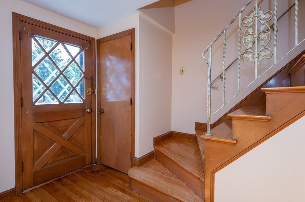 114 Spring Street Stoneham, MA 02180 - Photo 5 of 41 a view of entryway with wooden floor and stairs