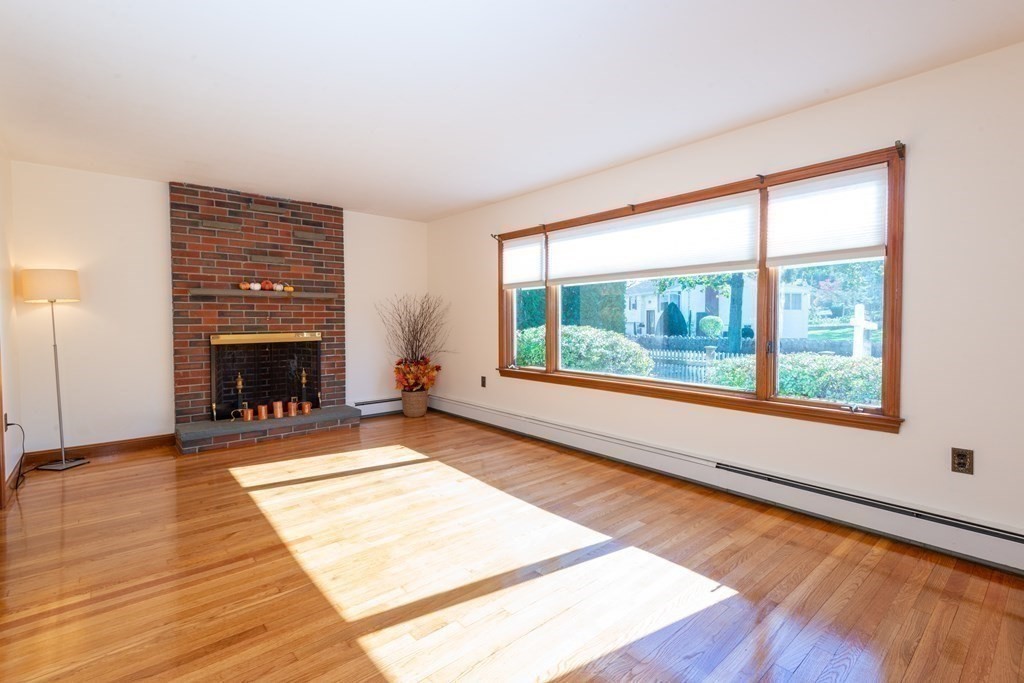 114 Spring Street Stoneham, MA 02180 - Photo 7 of 41 a view of an empty room with wooden floor and a window