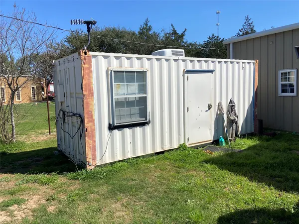 a view of backyard with cabin