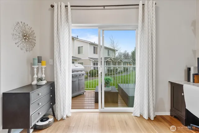 a view of a hardwood floor and a large window