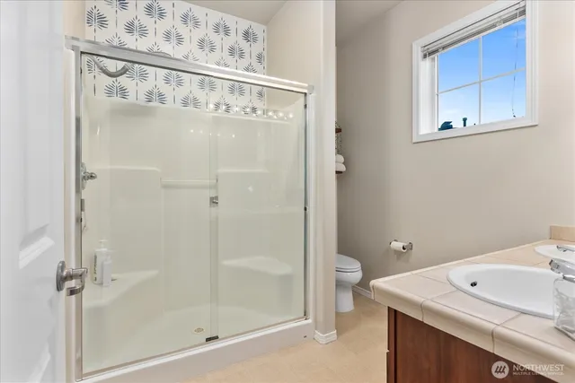 a bathroom with a shower and sink