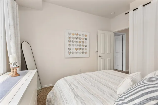 a bedroom with a bed and a large window