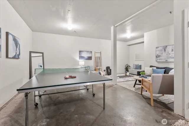 a room with table chairs and white walls