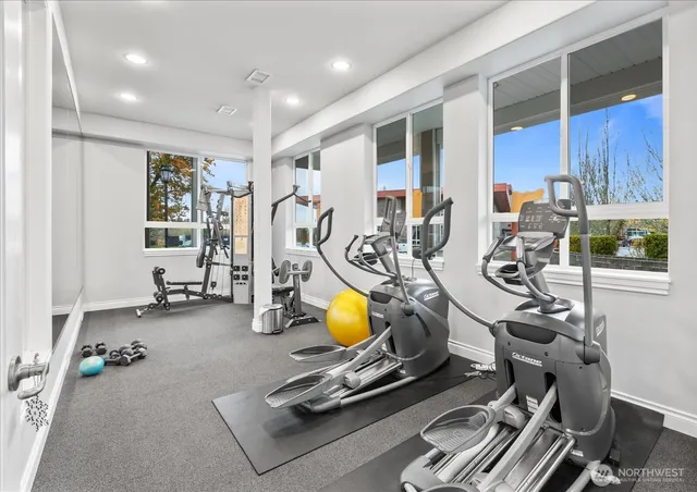 a room with gym equipment and windows