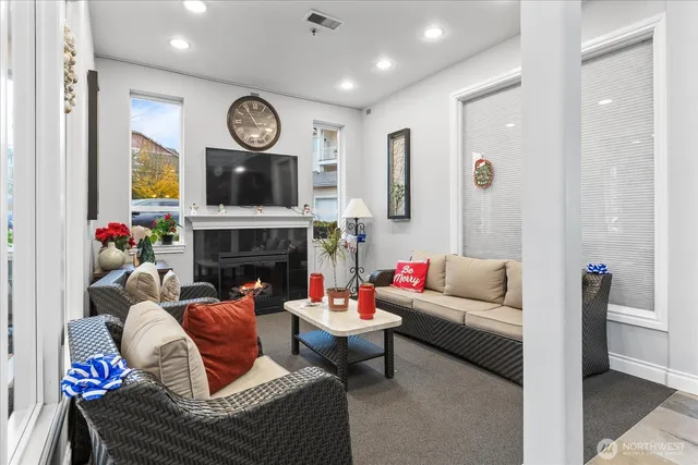 a living room with furniture a clock and a fireplace