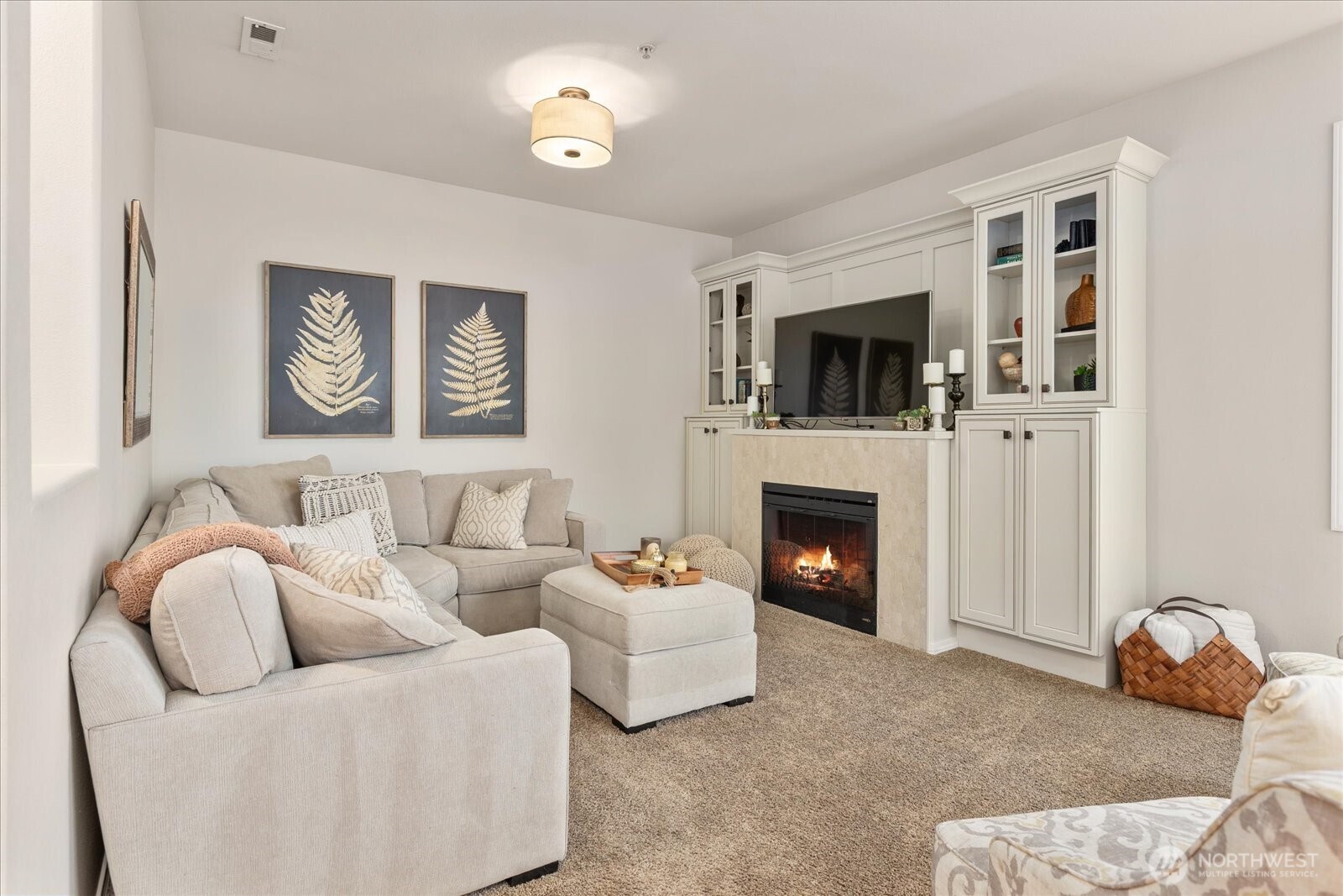 14915 38th Drive Southeast, Unit S1148 Bothell, WA 98012 - Photo 4 of 37 a living room with furniture a flat screen tv and a fireplace