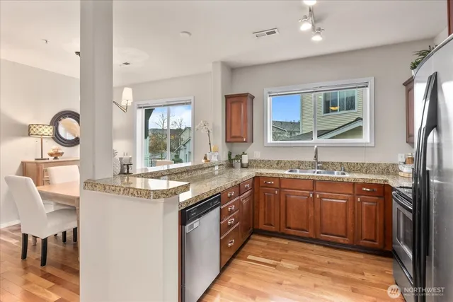 a kitchen with stainless steel appliances granite countertop a sink and stove